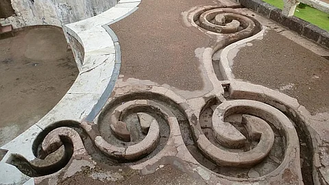 An intricate set of curlicues set in the floor leads rainwater from the roofs to a tank in Jahaz Mahal, Mandu