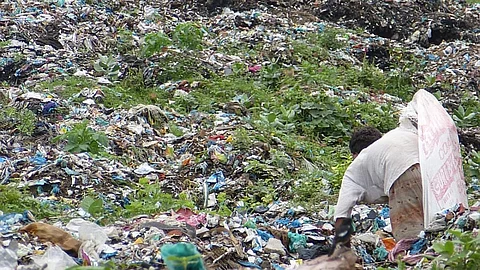 A wastepicker in a sea of garbage