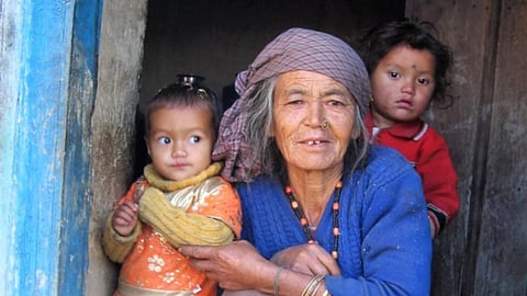 A woman with her grandchildren in her Munsyari home.