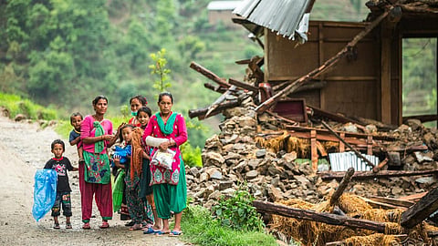 A family beside a damaged house near Naglebhare, Nepal (Source :Asian Development Bank)