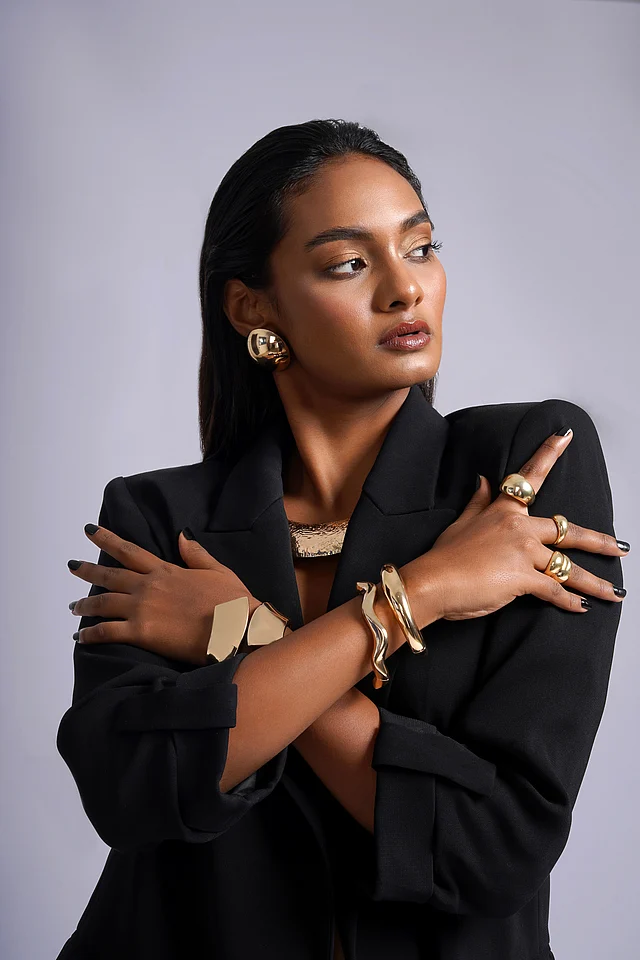 Editorial shot of Joker & Witch’s Liquid Gold collection—highlighting the duality of strength and softness in gold-toned accessories.