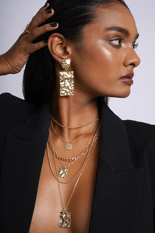 Fluid gold earrings from the Liquid Gold capsule—bold, molten-inspired statement jewellery.