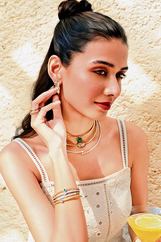 Minimalist gold bangles with white diamonds, reflecting the understated elegance of the Zoori collection.