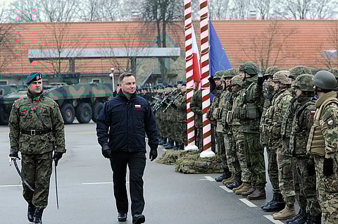 Andrzej Duda conducts a pass and review on the parade field during the closing ceremony of ANAKONDA 18 at the Headquarters Multinational Division – North East in Elblag, Poland, Dec. 6, 2018.