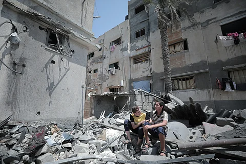 Palestinian Kids sitting inside of destroyed building in Gaza