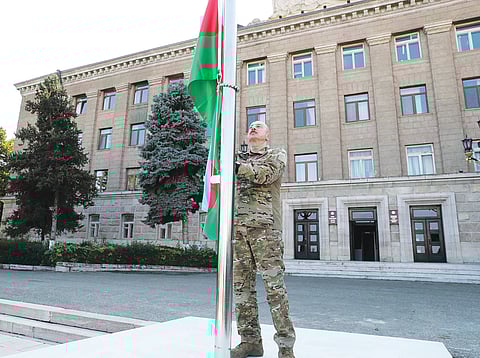 President of Azerbaijan, Ilham Aliyev, raises the Azeri flag in Khankendi, formerly known as Stepanakert and former capital of the Republic of Artsakh, 2023.
