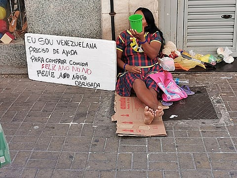 A homeless Immigrant Venezuelan asking for help on the street.