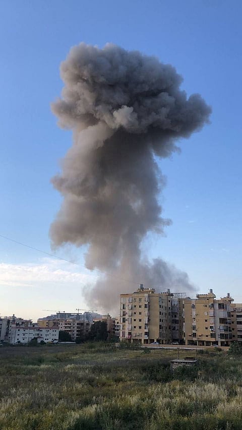 A massive plume of smoke rises over Beirut following the Israeli airstrike, 27 April 2025.