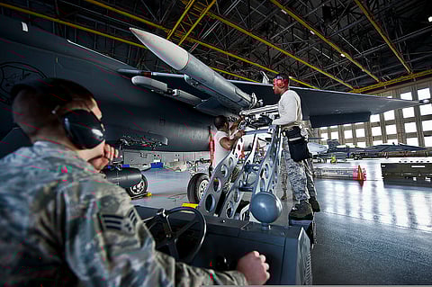 U.S. Airmen connect an AIM-120 to an F-15 Eagle aircraft at Eglin Air Force Base, Fla., Feb. 14, 2014.