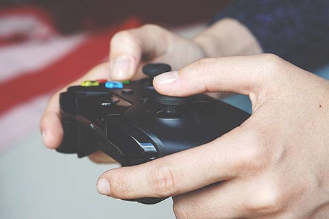 A man playing a videogame using a controller.
