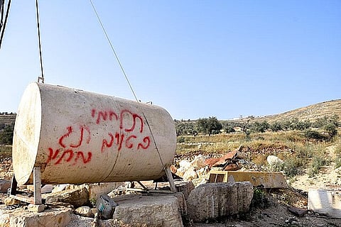 “Fight the enemy. Price Tag.” Graffiti settlers spray-painted in Hebrew on a water tank in the village of ‘Urif, Nablus District. Photo by Salma a-Deb’i, B’Tselem