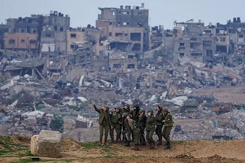 IDF soldiers pose for a selfie amid Gaza's rubble.