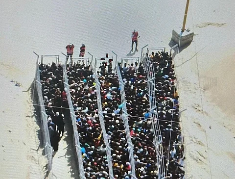 Desperate Palestinians in Gaza navigate barriers for scarce food rations, part of a so-called 'humanitarian project'.