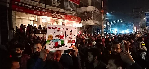 Man holding anti RSS CAA NRC BJP poster