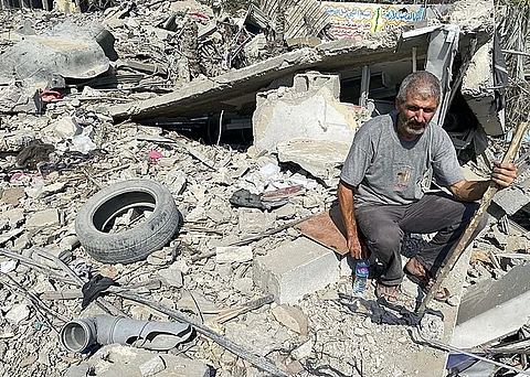 Palestinians inspect the damage following an Israeli airstrike on the El-Remal aera in Gaza City on October 9, 2023.