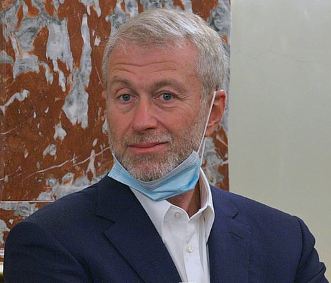 Roman Abramovich, sanctioned by the UK for alleged Kremlin ties, faces legal threats over his refusal to allocate £2.5 billion from Chelsea's sale solely to Ukrainian humanitarian aid.