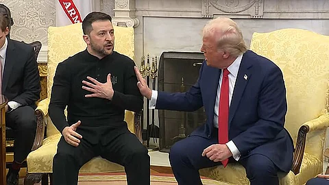 President Trump lightly pushes Ukrainian President Zelenskyy on his shoulder during meeting in Oval Office on Feb. 28, 2025