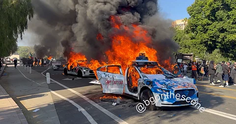 Multiple Waymo cars were set on fire by protestors in Los Angeles.