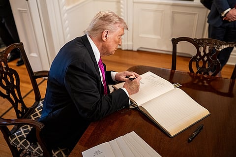Trump signs the guest book at West Point Military Academy May 24, 2025, in West Point, New York