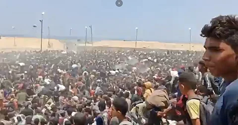 Starving Gazans crowd US-backed aid sites, risking death under Israeli bombardment.