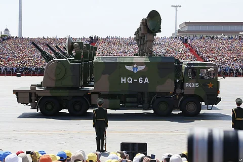 Military vehicles carry radar arrays for HQ-6A surface-to-air missile batteries during a parade commemorating the 70th anniversary of Japan's surrender during World War II