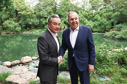 Sergey Lavrov shaking hands with Foreign Minister of the People’s Republic of China Wang Yi