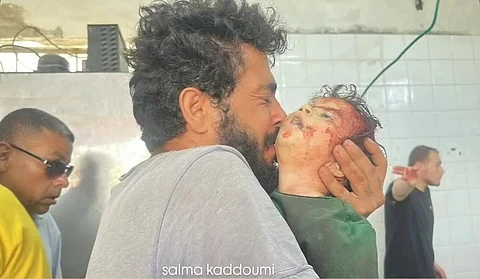 A Palestinian man holding a child killed by an Israeli strike on the Gaza Strip.
