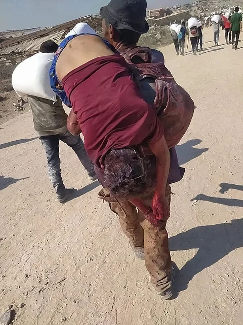 A man carrying his dead brother after an attack by Israeli forces in Gaza.
