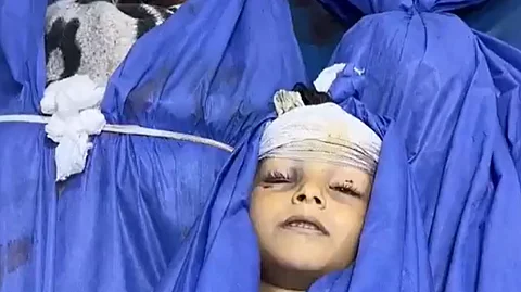 A child, among others, killed by an Israeli airstrike on residential homes targeted in Al-Nuseirat.