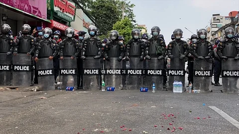 Police in front of protestors at Hledan Yangon, during 2021 protests against the coup.
