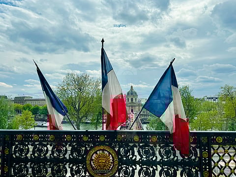 Three flags of France on display at the Louvre Museum in beautiful Paris, France.