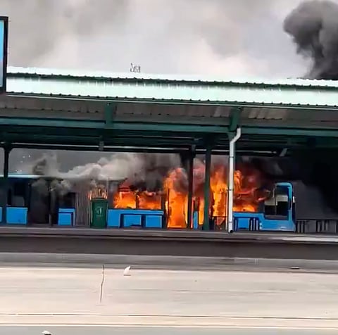 Buses burn during street protests in Dar es Salaam on October 30, 2025, triggered by the disqualification and jailing of key opposition figures ahead of Tanzania's October 29 presidential election.