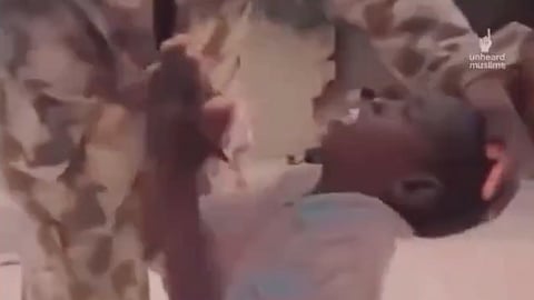 A Sudanese child begs a soldier to let him stay alive.