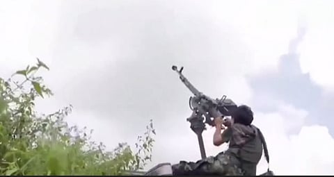 A Cambodian soldier attempts to shoot down a Thai F-16 with a machine gun.