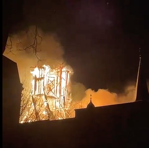 Intense flames engulfing the tower of the Vondelkerk.