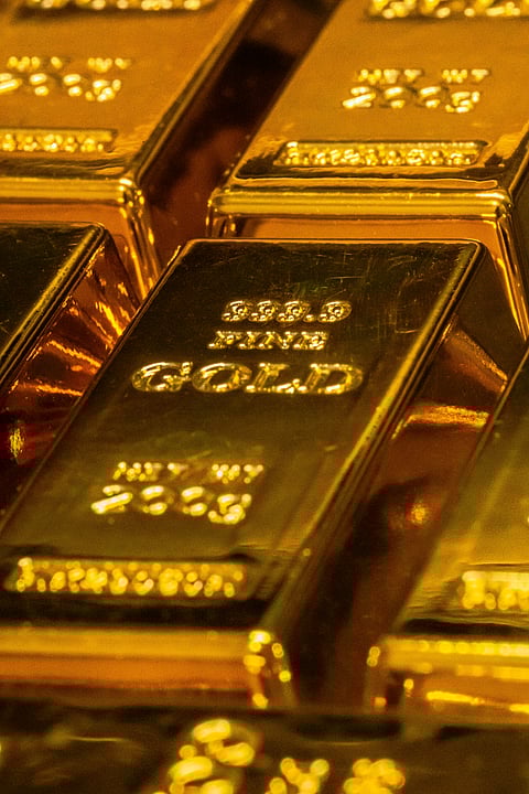 Gold Near $5,000 as Dollar Slips and U.S. Data Loom for Rate Outlook Policy