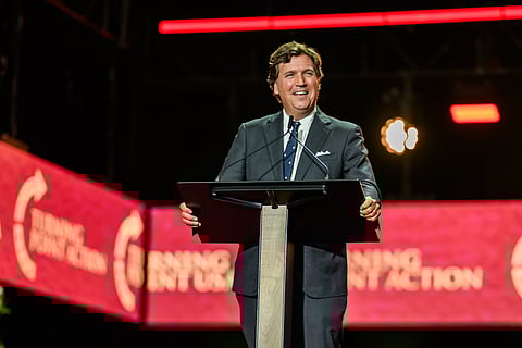 Tucker Carlson delivers remarks during the Memorial Service for Charlie Kirk at State Farm Stadium in Glendale, Arizona
