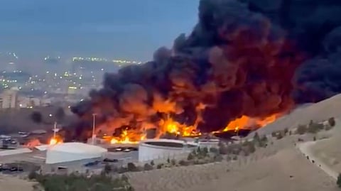 Fires burning at Iran's Shahran oil depot in Tehran after overnight U.S.-Israeli strikes.