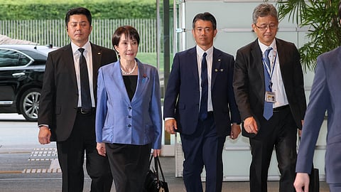 Sanae Takaichi walks into the Prime Minister's Official Residence (Kantei) on her first day as Prime Minister, 21 October 2025.