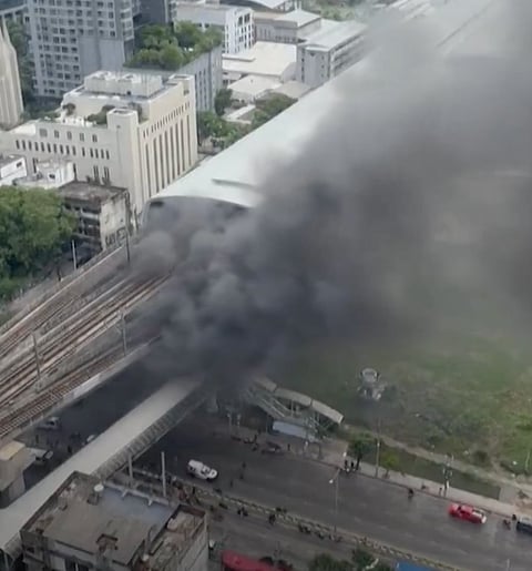 Thick black smoke rising from the collision.