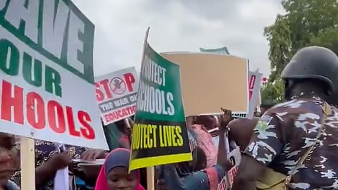 A June 2026 protest in Abuja demanding government action to protect schools and rescue abducted students/teachers after attacks in Oyo State.