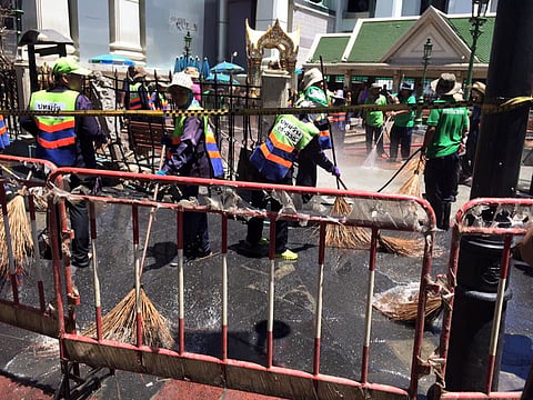 Clean-up crews work at the Erawan Shrine, site of the bomb explosion in central Bangkok, Thailand, Aug. 18, 2015