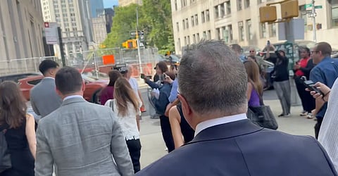 Crowds and media surrounding Luigi Mangione's defense team outside a Manhattan courthouse following a June 17, 2026 pretrial hearing.