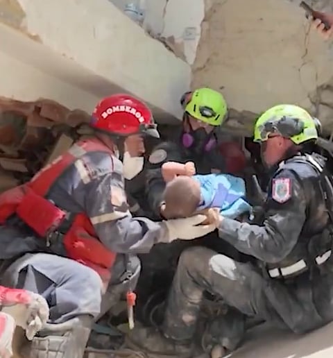 An infant rescued from beneath the rubble following the earthquake in Venezuela.