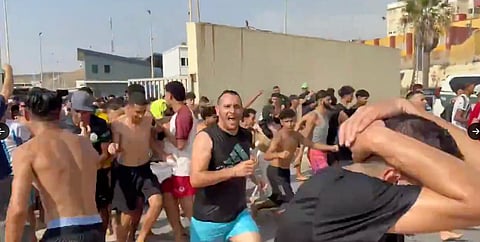 Chaotic scenes of thousands of mostly young men running excitedly through Ceuta streets.