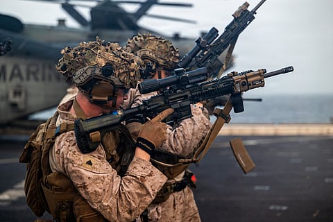 U.S. Marines train on the flight deck of USS Portland (LPD 27) as the ship sails in the Arabian Sea.