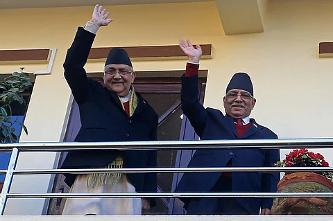 Nepal’s former guerrilla leader Pushpa Kamal Dahal, better known by his nom de guerre Prachanda waves next to Communist Party Nepal-Union Marxist Leninist (CPN-UML) chairman K.P. Sharma Oli in Bhaktapur on the outskirts of Kathmandu on December 25, 2022 before leaving for the President’s office to claim majority for his appointment as the new Prime Minister.