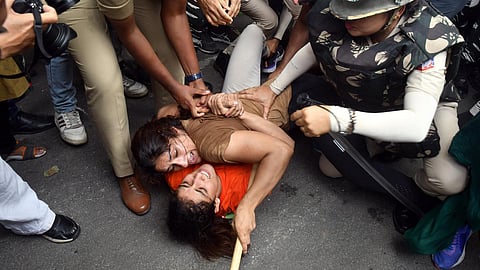 Wrestlers Vinesh Phogat and Sangeeta Phogat with others being detained by the security personnel during their protest march from Jantar Mantar to Parliament House, near WFI Chief’s residence, in New Delhi on May 28, 2023