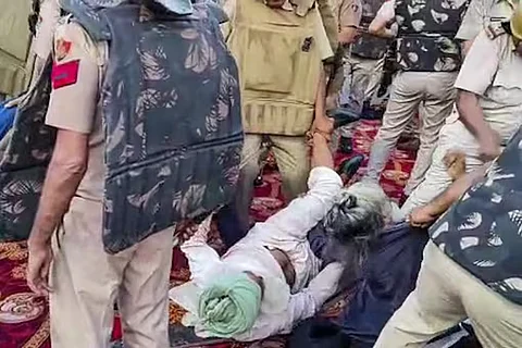 Police personnel detain farmers during their protest against the Haryana government’s decision to not buy sunflower seeds on the minimum support price (MSP), in Kurukshetra.