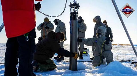 A prototype of a robot built to access underwater areas where Antarctic ice shelves meet land is lowered though the ice.